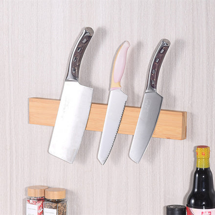 Wall-mounted magnetic bamboo knife holder with a modern minimalist design, includes two mounting screws for secure kitchen storage of knives and metal utensils.