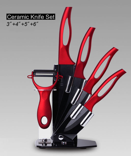 Six-piece black blade ceramic knife set with red handles, including 3-inch, 4-inch, and 5-inch knives, a melon planer, and a knife block—lightweight, rust-free, and modern in design.