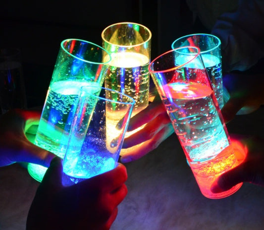 Transparent LED pour-sensor wine glass made from durable PS material with a 401-500ml capacity, glowing with vibrant, colorful LED effects—ideal for banquets and festive gatherings.