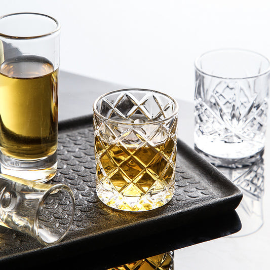 Elegant retro carved white wine shooter glass with intricate detailing, showcasing a mild luxury design crafted from high-quality glass.
