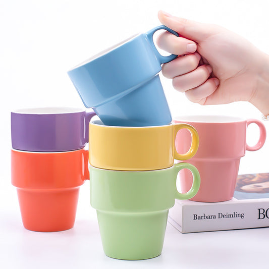 Vibrant stackable ceramic cups in yellow, purple, and orange designed for convenient storage and microwave use, with a capacity of 201-300ml each